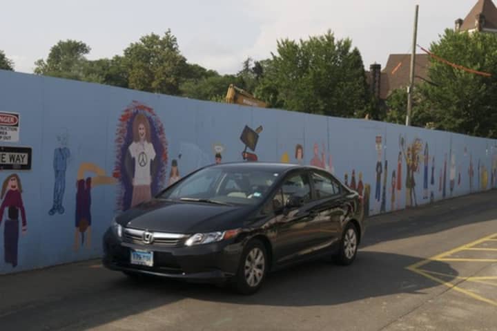 A mural surrounds the construction site at Bedford Square in downtown Westport 