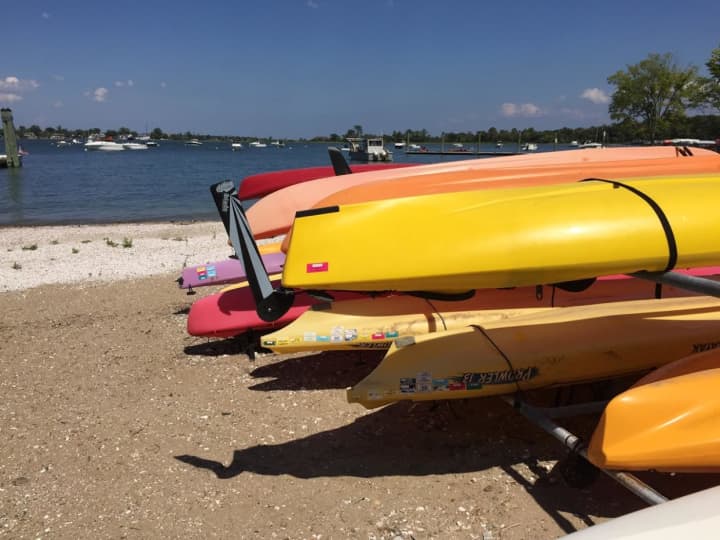 The kayaks are stacked up and ready to go at the Long Island Sound beach.