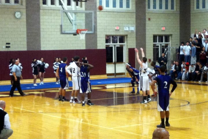 The Scarsdale High School boys basketball team, in white, started its season with a 50-23 win against Lincoln.