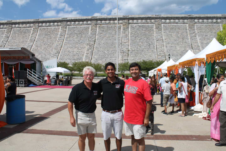 Mike Chiapparelli, coach of the Mamaroneck High School baseball team, left, with Kumar Nambiar and Sid Mehta at Sunday&#x27;s Heritage of India Festival where Nambiar was honored.