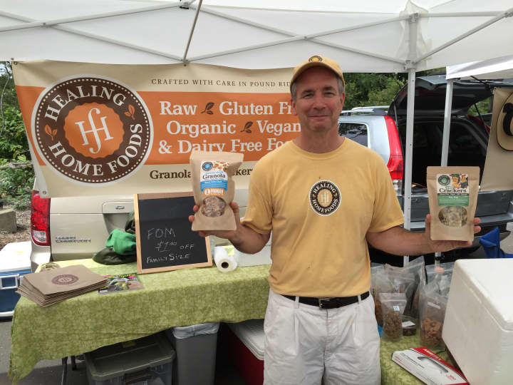John Schulz, owner of Pound Ridge, N.Y.-based Healing Home Foods, poses in front of his tent Thursday at the Westport Farmers Market.