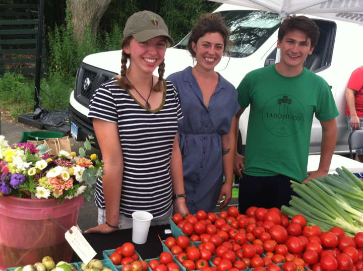 Alexis Barbalinardo, center, farm manager at Back 40 Farm, of Washington, CT., with interns Katie Carlson and Fred Baker at the Old Greenwich Farmers Market.
