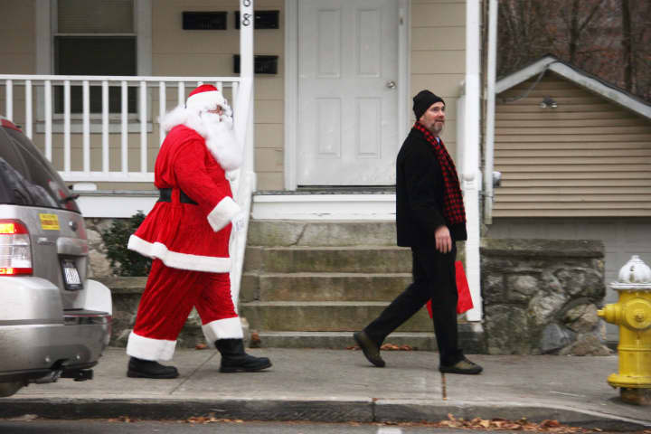 Gregory Schmidt , co-chair of the Croton Business Council, accompanies Santa to the tree-lighting ceremony.