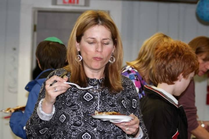 Diane Karsch tastes a latke at the Hebrew Congregation of Somers&#x27; annual Latkepalooza.