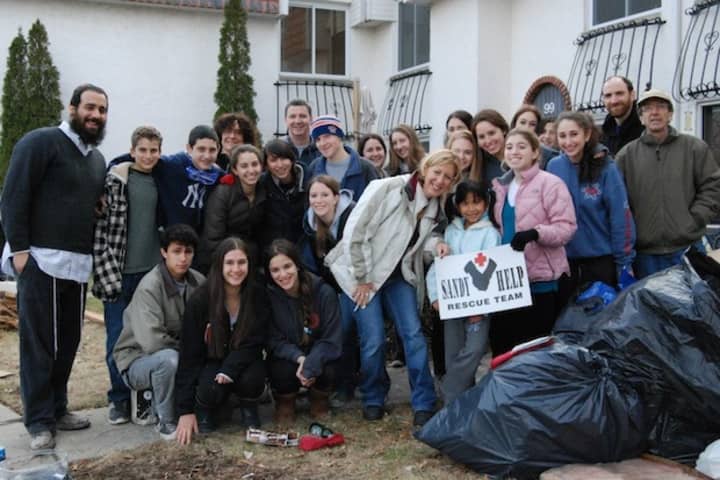 Students and faculty members of Solomon Schechter&#x27;s Disaster Relief Club gather for a photo in Long Island on Sunday, where they assisted families in rebuilding homes damaged by Hurricane Sandy.