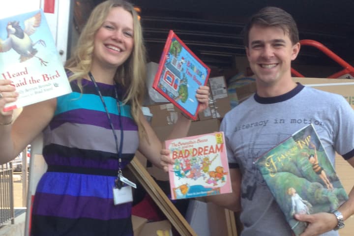 Literacy in Motion Executive Director Joseph Musso and Erin Shea, head of adult programming at the Darien Library, collect books for the drive.