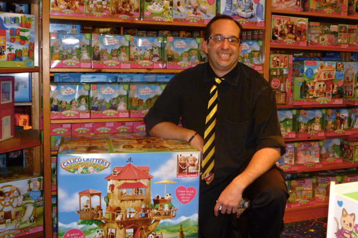 Andrew Lev, manager of Smart Kids Toys in Greenwich, displays some Calico Critters, which have been among his hottest-selling toys this holiday season.