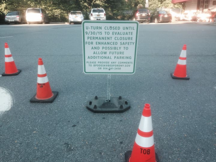 Signage and cones posted to block off the median gap along Katonah Avenue.