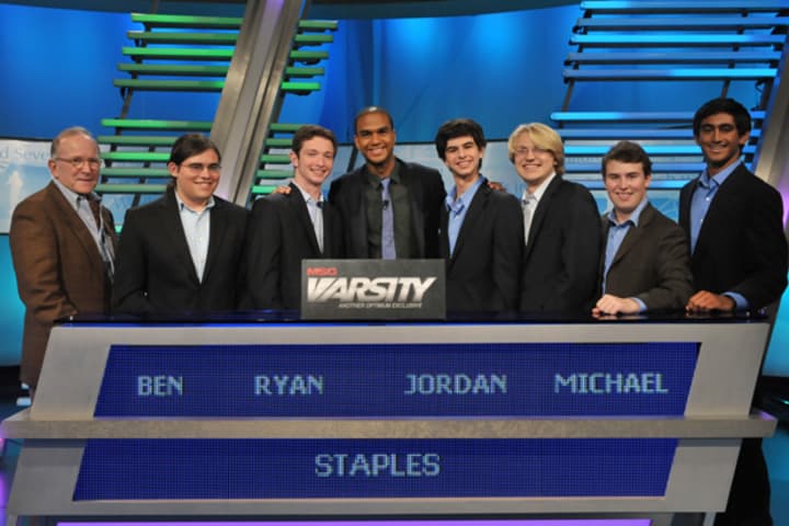 Staples High School students chosen to compete on MSG Varsity&#x27;s &quot;The Challenge&quot; pose with team academic adviser Jim Goodrich, left, and show host Jared Cotter, center.