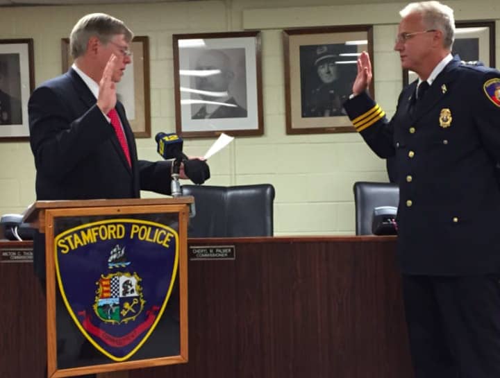 Mayor David Martin swears in Tom Wuennemann as the new Assistant Chief of the Stamford Police Department on Wednesday.