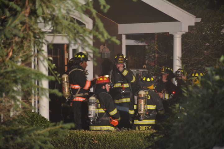 Firefighters respond to a fire in an Armonk house&#x27;s attached garage.