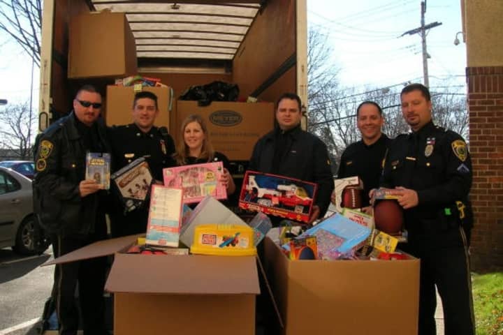 Members of the Fairfield Police bring toys to Bridgeport Hospital after a previous year&#x27;s toy drive.