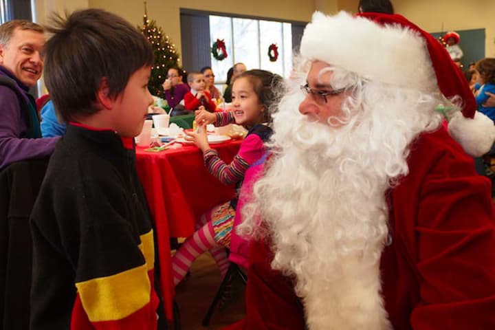 A child at last year&#x27;s Breakfast with Santa event tells Santa what he wants for Christmas.