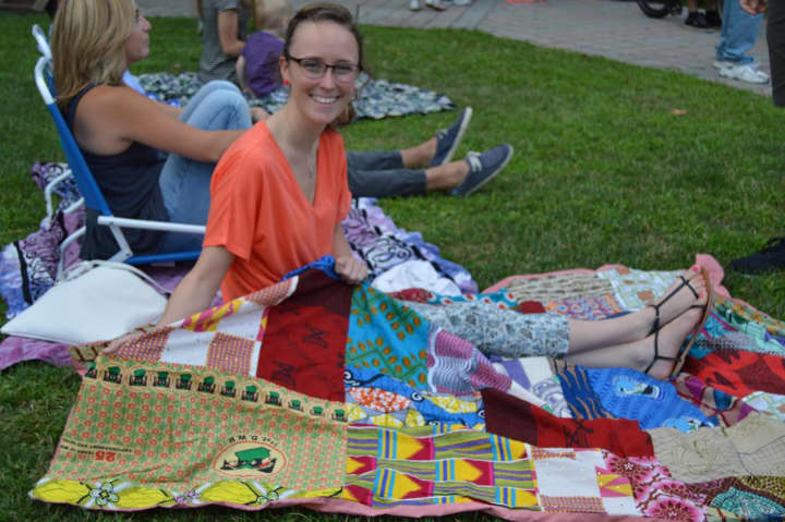 A fan stretches out on her drumming blanket from Ghana for the Afrikan Drumming Concert on the Green in Danbury. 