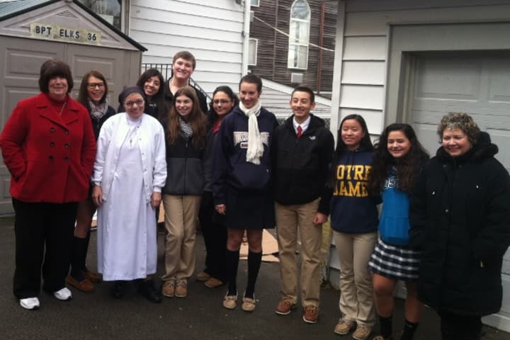 Notre Dame-Fairfield&#x27;s Key Club members and advisers brought donations to Sister Theresa Tremblay. (See story for identifications.) 
