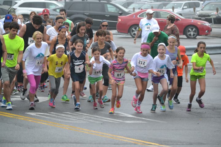 Children and families take off from the starting line at the 2014 Kisco 5K Road Race.