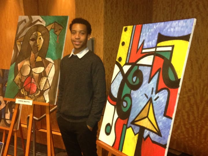 Chris Watts displays his paintings at the Harlem Fine Arts Show in White Plains Thursday.