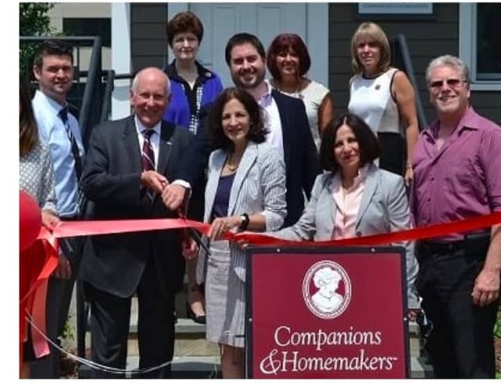 Elected officials join Companions &amp; Homemakers staff in cutting the ribbon to celebrate the opening of their new office in Westport.