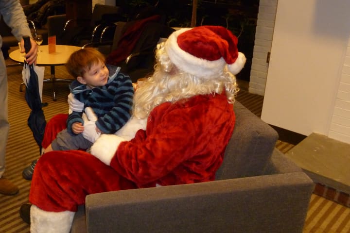 Leo Equale, 23 months, meets with Santa on Friday at the Wilton Holiday Stroll. 