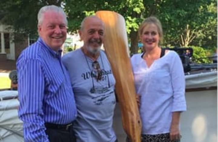 First Selectman Mike Tetreau, Andy Kosch, who is holding a propeller, and Selectman Sheila Marmion standing next to the replica that was displayed at Sherman Green.
