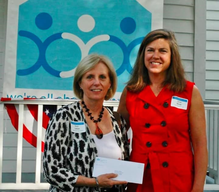 Carrie Bernier, The Community Fund of Darien executive director, right, presents a check for $25,000 to AmeriCares Free Clinics Executive Director Karen Gottlieb.