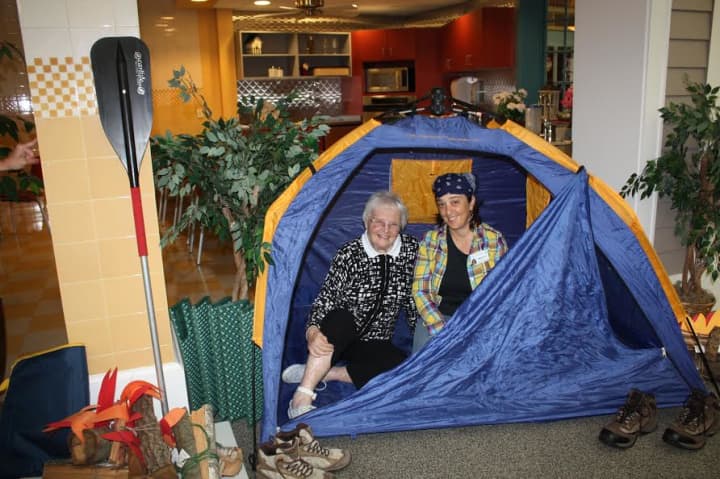 A camper from Waveny LifeCare&#x27;s Adult Day program enjoys time in a tent.
