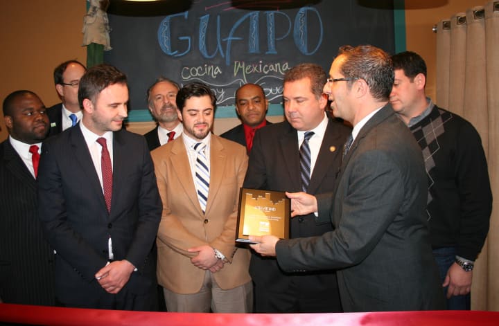 Edi Dedi  (left) and Nando Paterra (center) celebrate the grand opening of their newest restaurant, Guapo, last week with city officials in downtown Yonkers. 