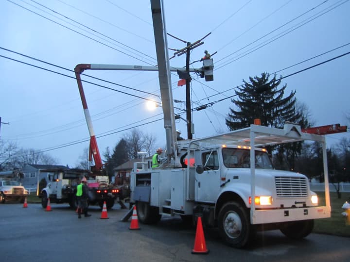 Con Edison crews work Monday afternoon to make permanent repairs to power lines along Spruce Road in Briarcliff Manor. 