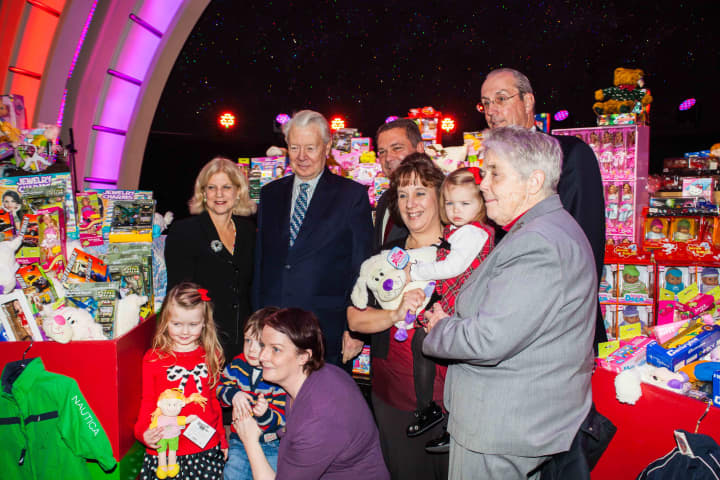 Empire City Casino current CEO Timothy Rooney (center) joined city and county officials in presenting hundreds of donated toys to Catholic Charities inside Empire City Casino, which now may be sold to MGM Resorts.