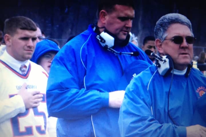 Former Danbury football coach Rick Davis, right, watches a game with P.J. Prunty, left, and Dan Donovan, then an assistant coach for the Hatters. Donovan is now the team&#x27;s head coach. Davis died Monday at age 64 after a bout with pancreatic cancer.
