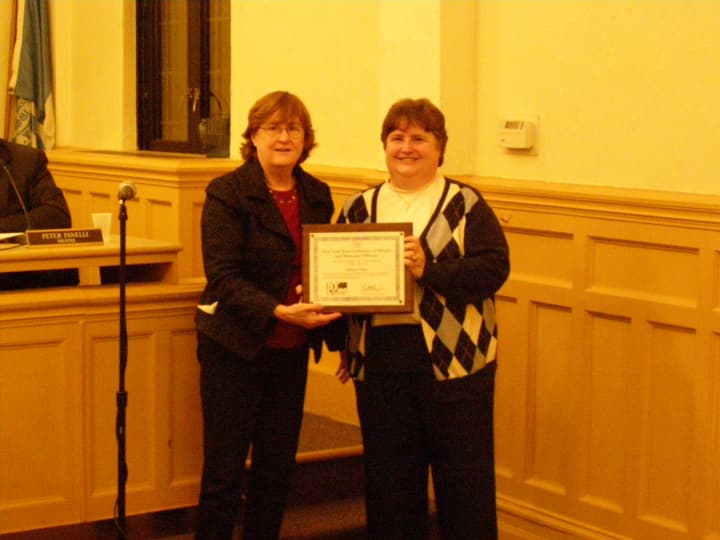 Mayor Anne H. McAndrews presents Eileen Finn, village clerk, with the NYCOM Service Award