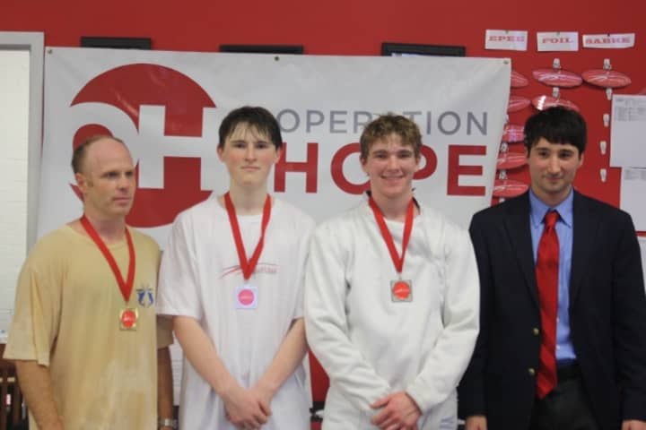 From left: Saturday&#x27;s tournament winners Alexander Turoff, Matt Love and George Whiteside pose with Fairfield Fencing Academy Director Jim Roberts.