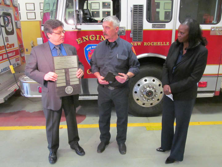 New Rochelle firefighter Byron Gray is awarded Liberty Mutual&#x27;s Firemark award at the city&#x27;s station three firehouse Thursday.