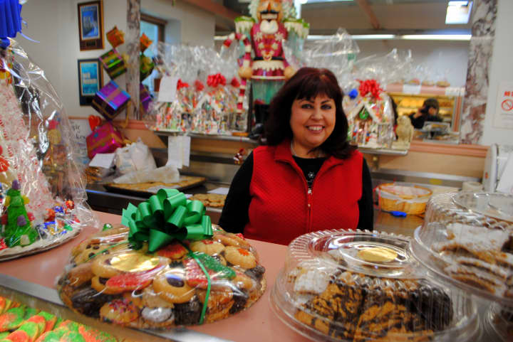 Rose Sanca, owner of Homestyle Desserts Bakery, stands behind the counter of the retail side of her Cortlandt bakery. 