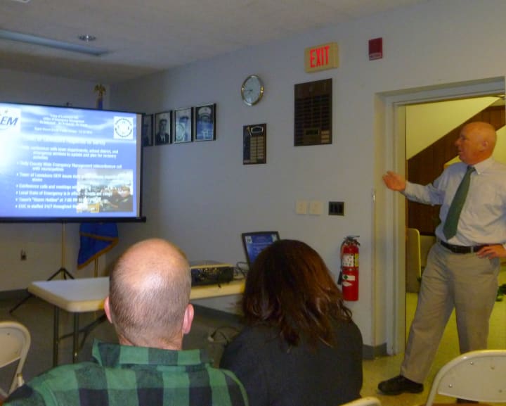 Adam Ochs, standing, director of the Lewisboro Office of Emergency Management, gives his presentation during the Hurricane Sandy forum Wednesday night.
