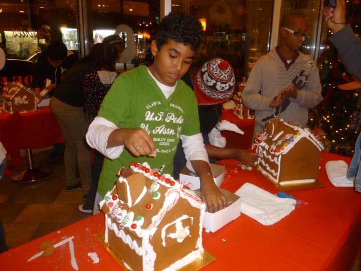Majdi Issa of Yonkers works Thursday evening during the third annual Gingerbread House Young Decorators Showdown inside La Pinata Bakery on New Main Street in Yonkers.