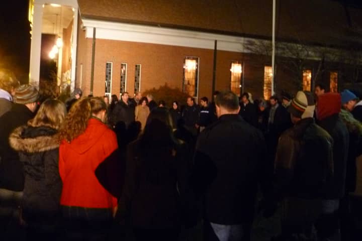 Residents form a prayer circle outside of Saint Rose of Lima Catholic Church in Newtown during a vigil Friday to remember the people who died in a shooting at Sandy Hook Elementary School. 