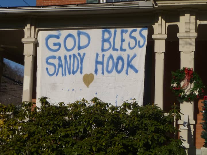 Sign posted in Sandy Hook center Saturday expresses remorse for the mass slayings at Sandy Hook School.
