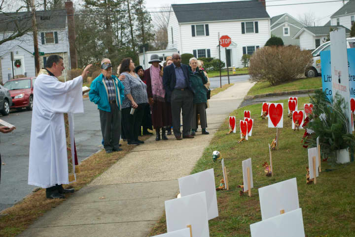 Rev. Eric Hall dedicates the memorial garden for victims of Friday&#x27;s shooting at Sandy Hook Elementary School in Newtown, Conn. at Eastchester Community Church.