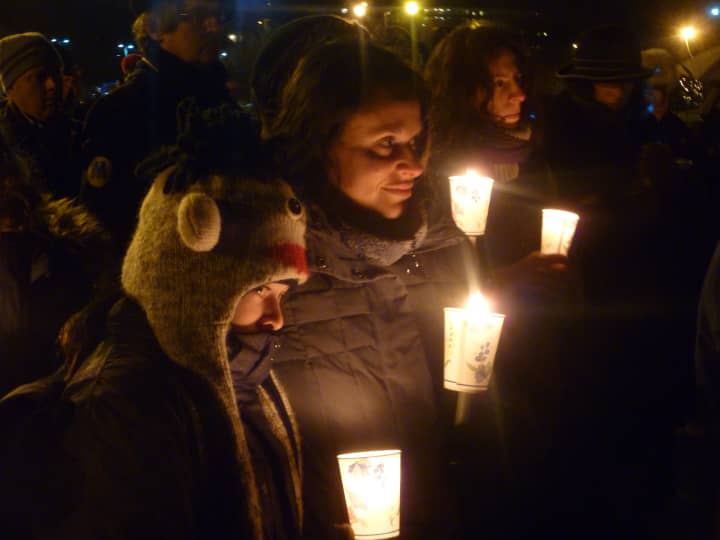 Dobbs Ferry&#x27;s Juli Klein and her daughter, Ashley, 11, honor the victims of the Newtown, Conn., school shooting during a  candlelight vigil Sunday in Waterfront Park in Dobbs Ferry. 