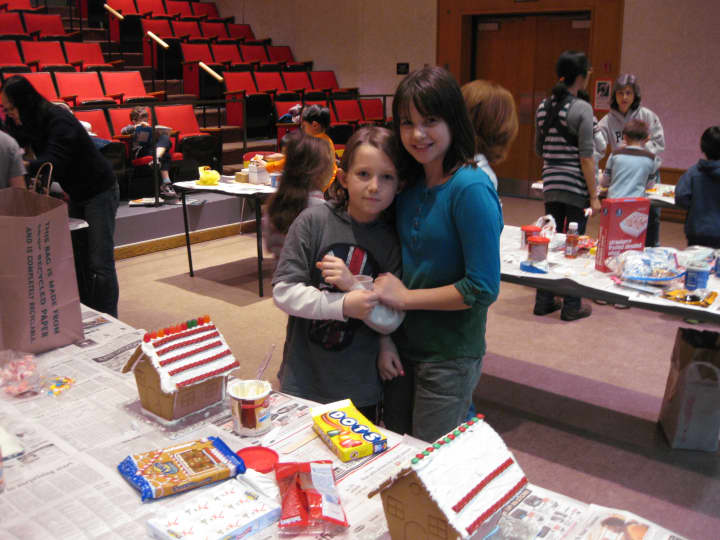 Third-grader Aidan Foster and his sixth-grade sister, Ava, worked on a pair of cottage homes Tuesday night in the Chappaqua Library Theater.