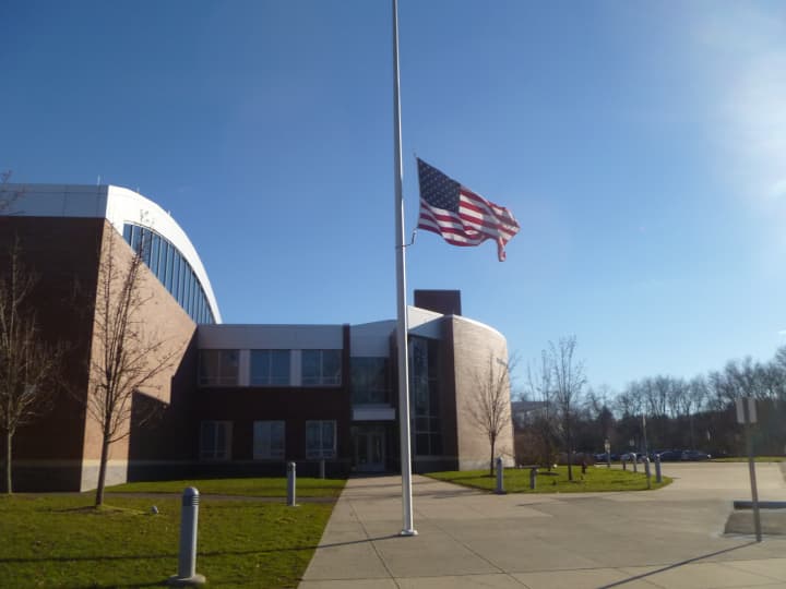 Flag at half mast in front of Weston Intermediate School honors Newtown victims.