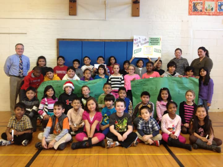 Students at Park Avenue School in Danbury proudly show off giant checks representing the funds raised for Hurricane Sandy and Sandy Hook Elementary School victims.