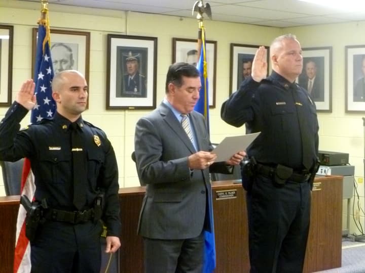 Steve Perrotta (left) and Chris Broems (right) take the oath of office as they are sworn in as sergeants with Stamford Police. 