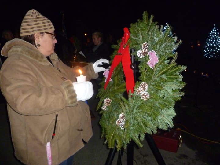 A Yorktown resident pins the name of Sandy Hook victim onto a wreath.