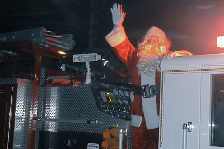 Santa waves to the crowd from an Elmsford Fire Department truck during the village Christmas tree lighting Dec. 4.