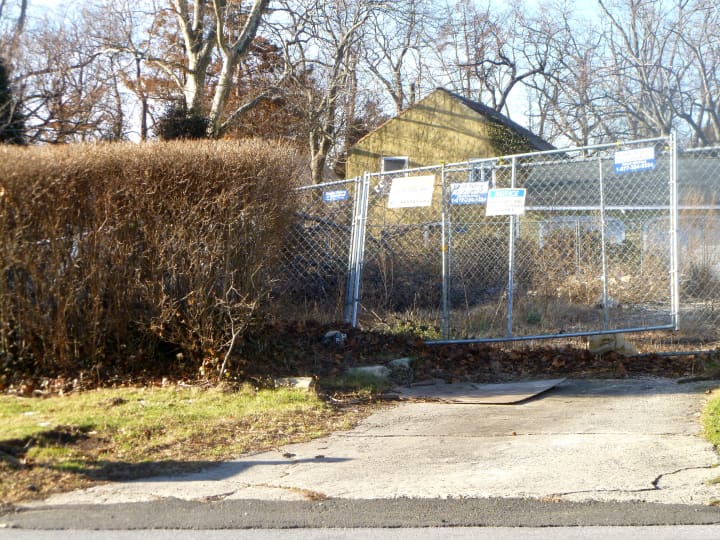The property where the Christmas Day fire took place in Stamford last year remains fenced off to keep people out. 