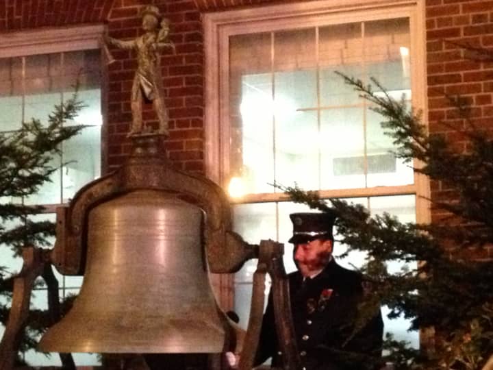 Captain Lawrence Lee of Union Hose Company No. 2 rings the bell in front of Sleepy Hollow Village Hall in honor of the victims of Sandy Hook.