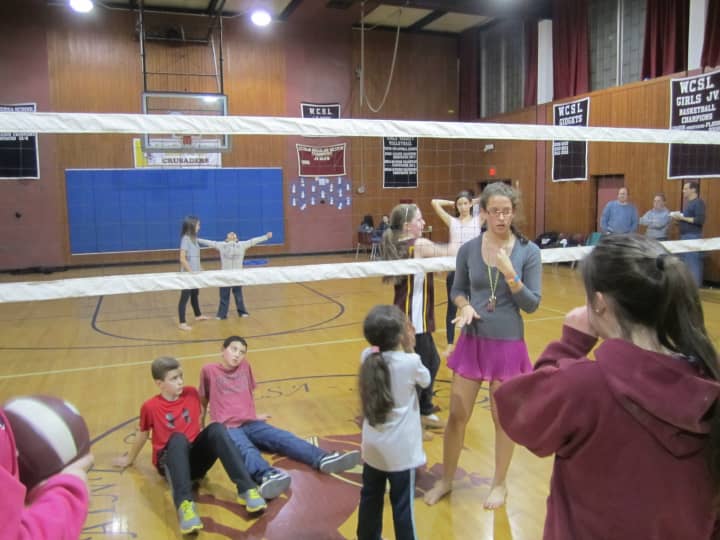 St. Theresa School alumnus Tara Hammonds, 16, organizes a volleyball game with community members and kids during &quot;Occupy St. Theresa&quot; Saturday night. 