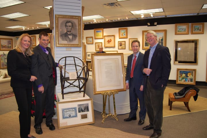 From left, Tiffany Benincasa, owner of C. Parker Gallery, is with John Reznikoff and Seth Kaller, owners of History You Can Own, and Steve Rockwell Desloge owner of Rockwell Art &amp; Framing. They display several artifacts related to Abraham Lincoln.